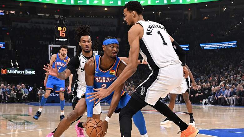 Shai Gilgeous-Alexander drives against Victor Wembanyama in Thunder vs Spurs game