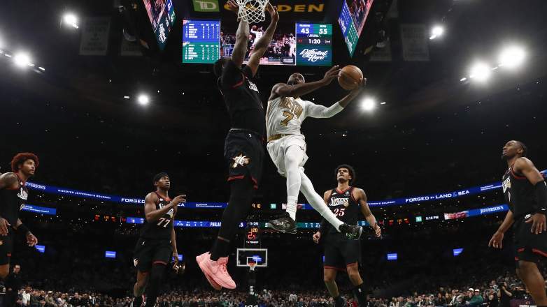 Jaylen Brown drives to the basket against 76ers defense at TD Garden