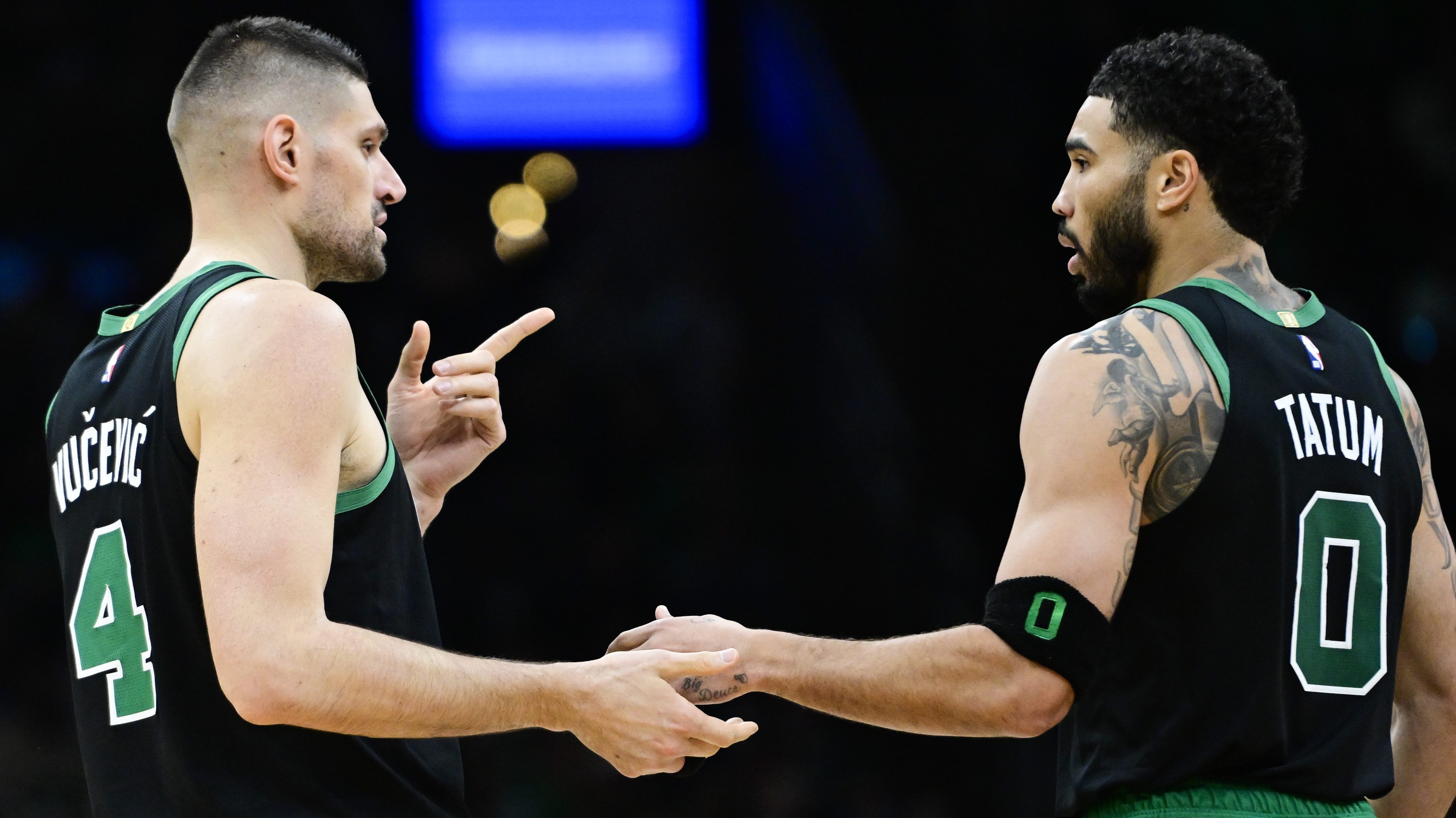 Nikola Vucevic #4 of the Boston Celtics and Jayson Tatum #0 of the Boston Celtics