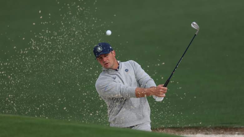 Bryson DeChambeau hits a bunker shot during a practice round at Augusta National ahead of the 2026 Masters
