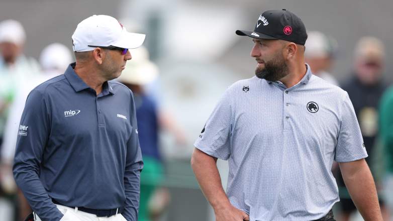 Sergio Garcia talks with Jon Rahm during a practice round at the 2026 Masters