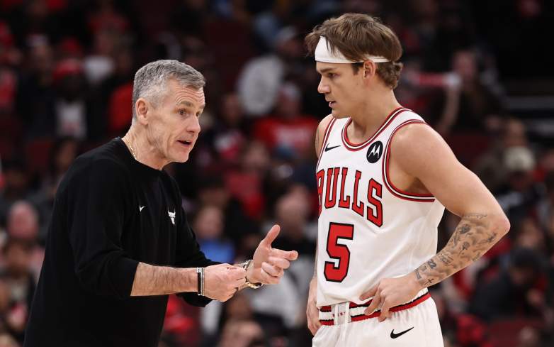 Mac McClung listens to Bulls coach Billy Donovan during game sideline interaction