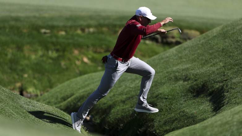 Sergio Garcia jumps over a tributary of Rae’s Creek during the first round of the 2026 Masters