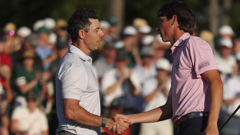 Rory McIlroy shakes hands with amateur Mason Howell after Round 2 at the Masters