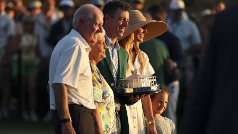 Rory McIlroy poses with wife Erica Stoll, daughter Poppy and parents after winning the 2026 Masters at Augusta National