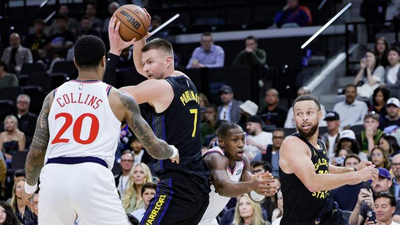 Stephen Curry cuts toward the basket as Kristaps Porzingis handles the ball during a Warriors game before play-in matchup vs Suns