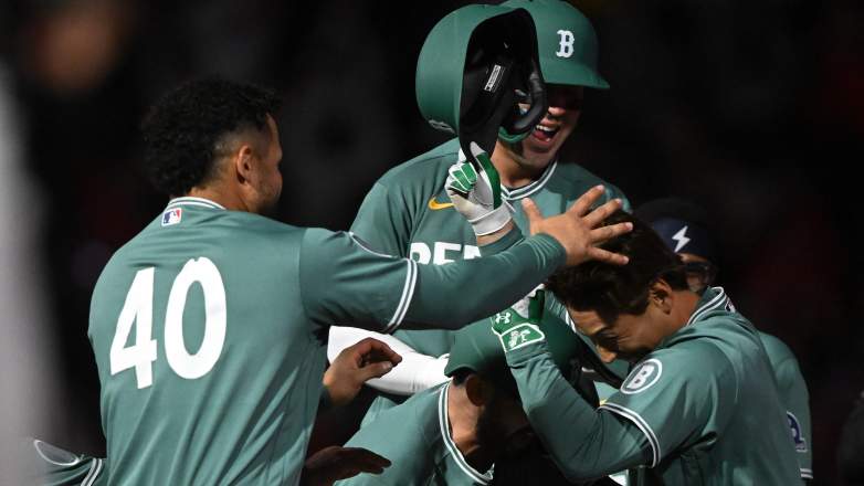 Masataka Yoshida celebrates with teammates after hitting a walk-off single for the Red Sox against the Tigers at Fenway Park