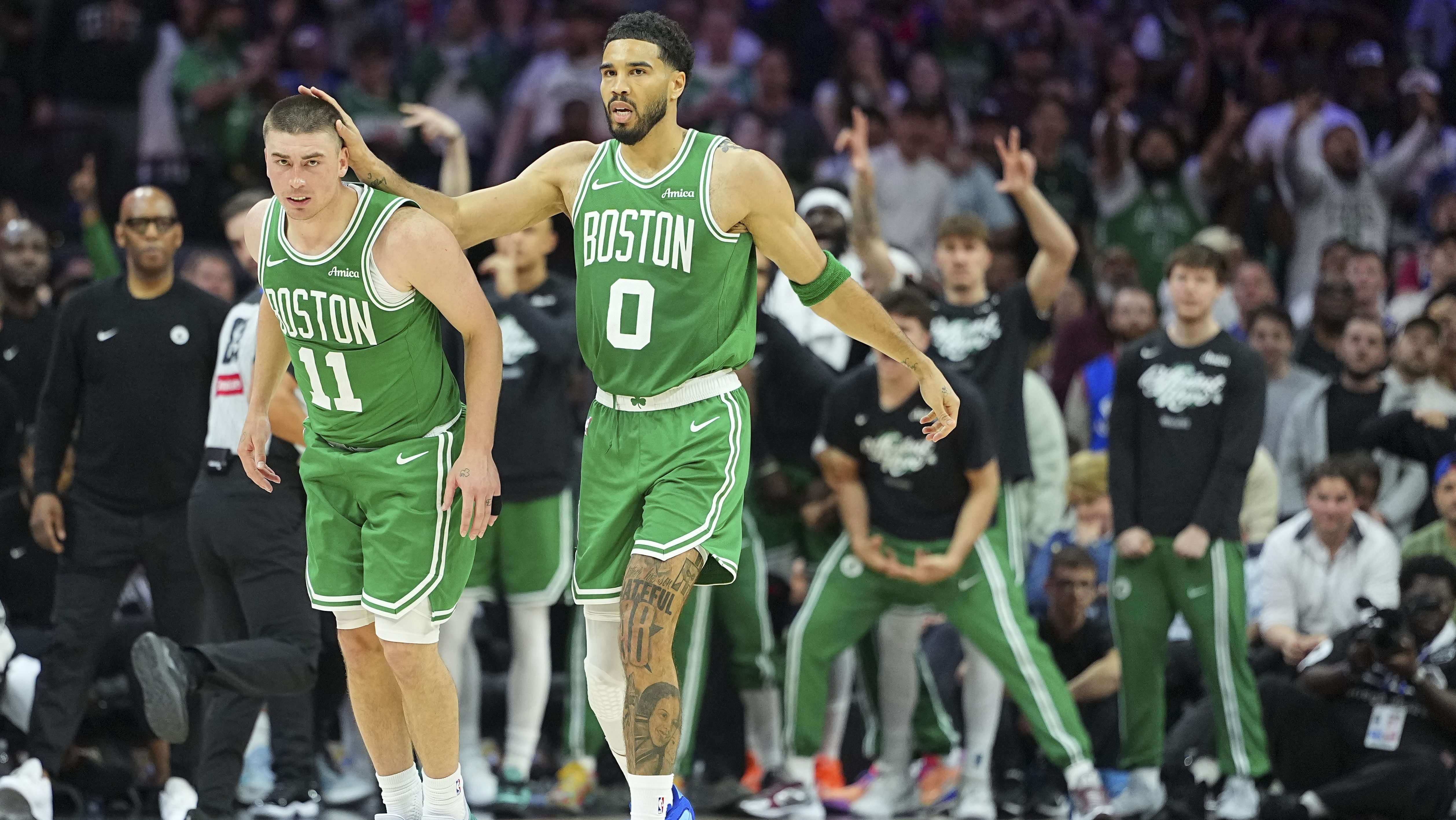 Jayson Tatum and Payton Pritchard celebrating during Celtics playoff win over 76ers