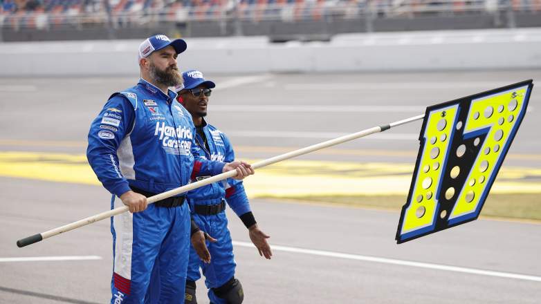 Jason Kelce holds pit sign while assisting Hendrick Motorsports crew at Talladega
