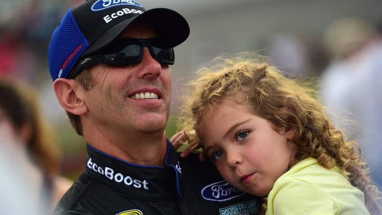Greg Biffle holds his daughter Emma on the grid before a NASCAR race at Daytona International Speedway