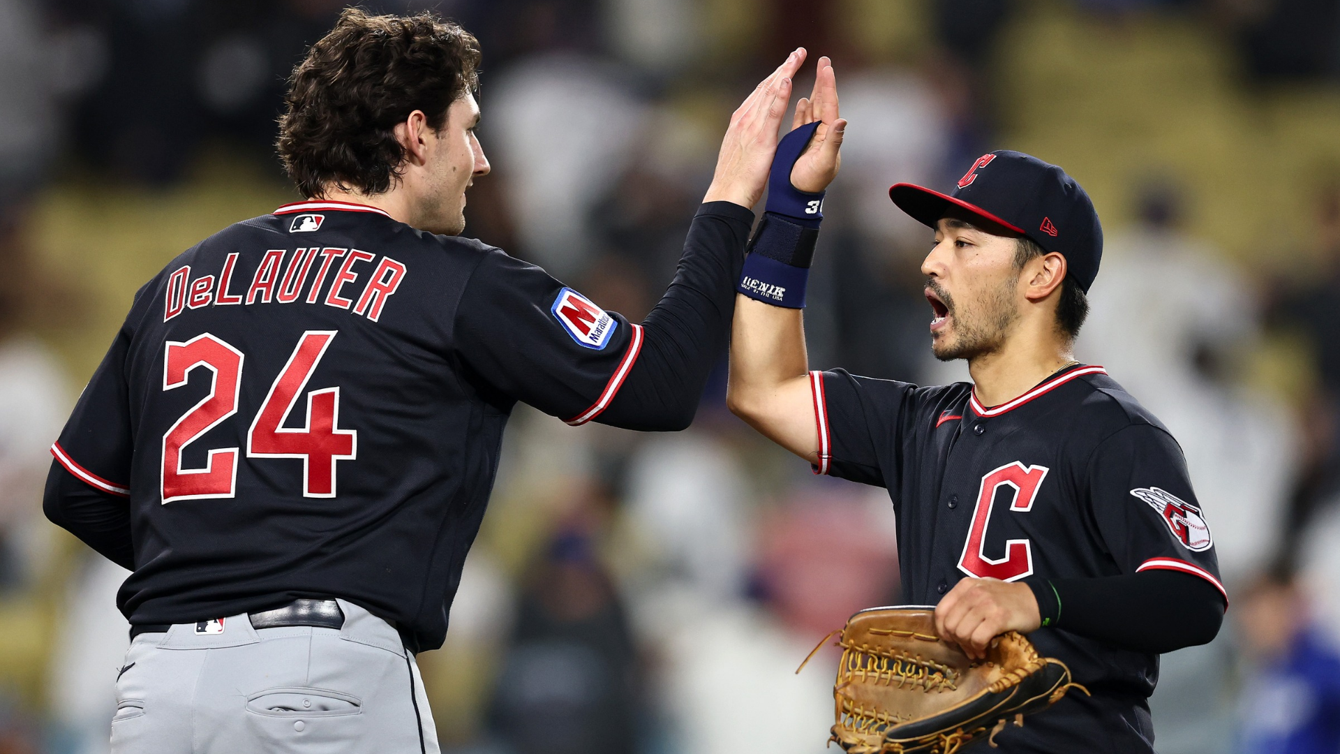 Chase DeLauter #24 and Steven Kwan #38 of the Cleveland Guardians embrace after defeating the Los Angeles Dodgers at Dodger Stadium on March 30, 2026 in Los Angeles, California. (Photo by Luke Hales/Getty Images)