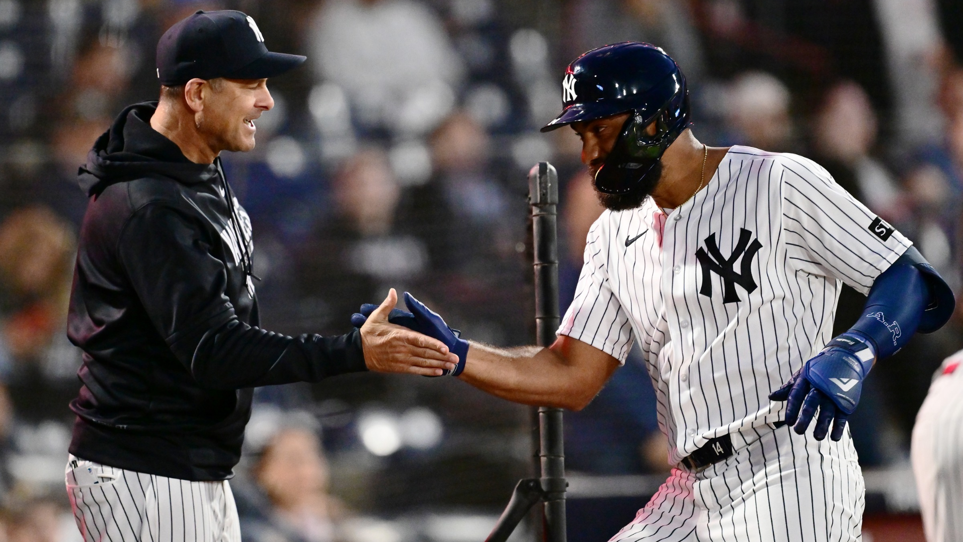 Amed Rosario #14 of the New York Yankees celebrates with manager Aaron Boone #17 after hitting a home run in the first inning against the Washington Nationals during a Grapefruit League spring training game at George M. Steinbrenner Field on February 25, 2026 in Tampa, Florida. (Photo by Julio Aguilar/Getty Images)