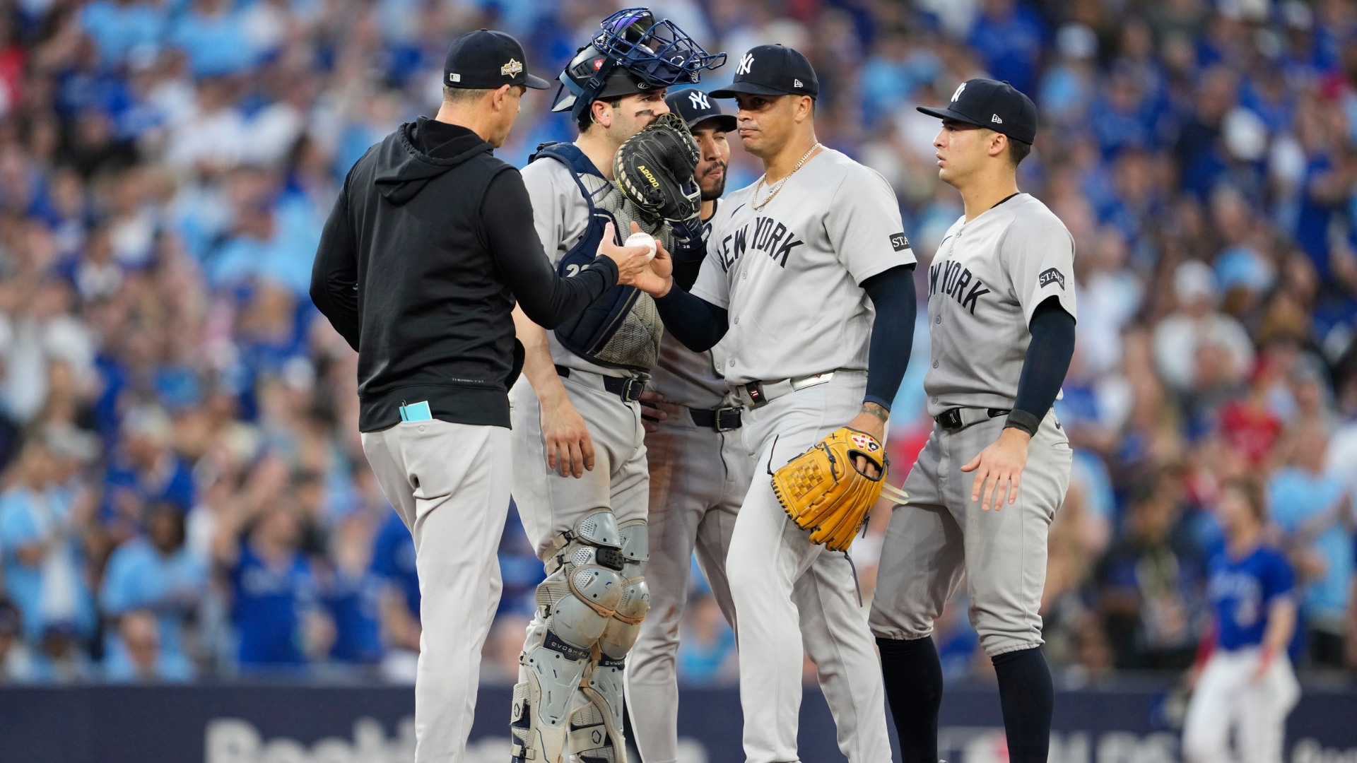 Manager Aaron Boone #17 of the New York Yankees removes Fernando Cruz #63 during the seventh inning against the Toronto Blue Jays in game one of the Division Series at Rogers Centre on October 04, 2025 in Toronto, Ontario. (Photo by Mark Blinch/Getty Images)