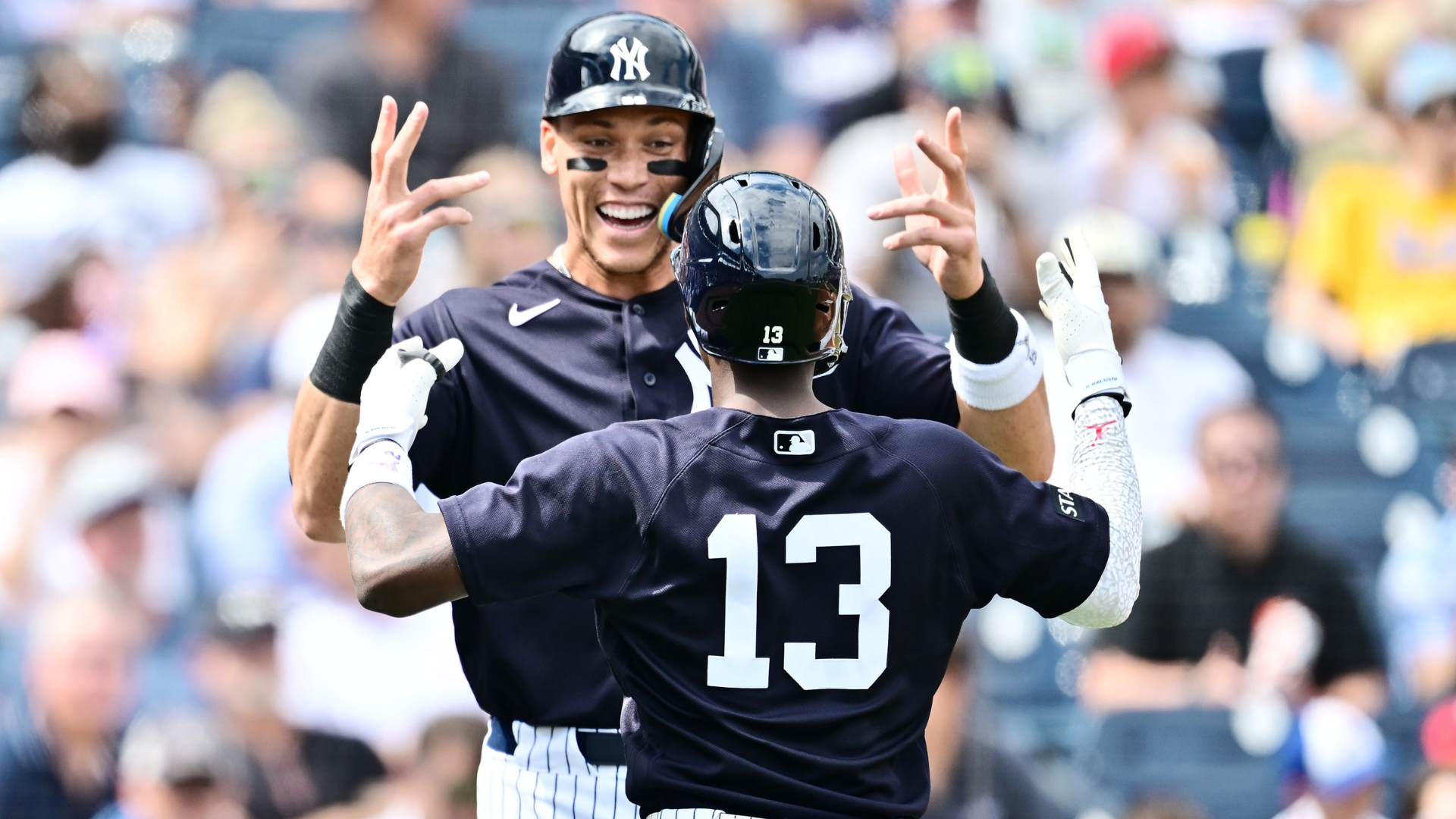 Jazz Chisholm Jr. #13 celebrates with Aaron Judge #99 of the New York Yankees after hitting a two-run home run in the first inning against the Atlanta Braves during a Grapefruit League spring training game at George M. Steinbrenner Field on February 26, 2026 in Tampa, Florida. (Photo by Julio Aguilar/Getty Images)