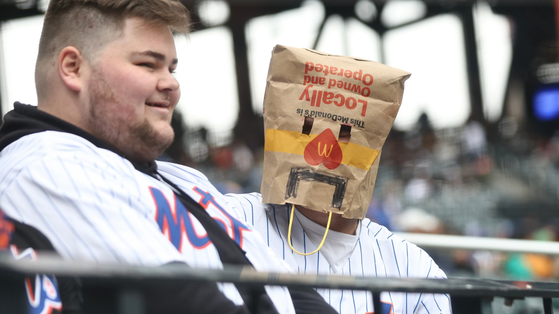 New York Mets fans wear a bag over their head before a game against the Washington Nationals at Citi Field on April 30, 2026 in the Queens borough of New York City. (Photo by Heather Khalifa/Getty Images)
