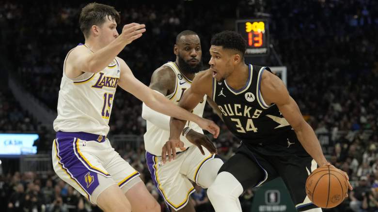 Giannis Antetokounmpo drives past Austin Reaves and LeBron James during Bucks vs Lakers game