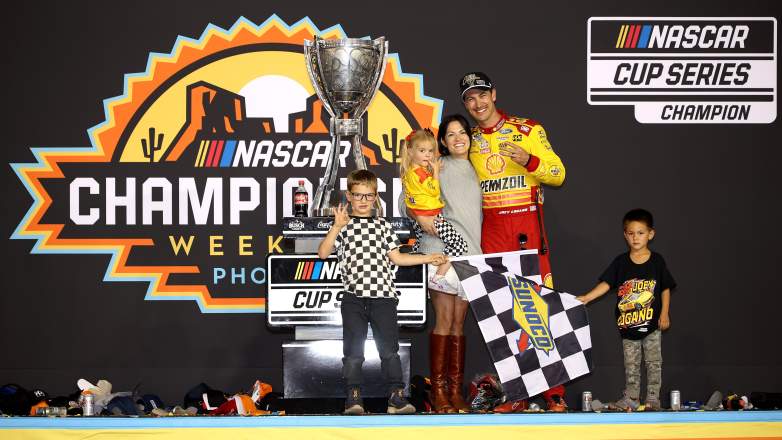 Joey Logano poses with wife Brittany and their children after winning the 2024 NASCAR Cup Series championship at Phoenix Raceway.