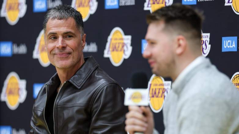 Rob Pelinka watches Luka Dončić speak during a Los Angeles Lakers event as the franchise evaluates offseason roster moves.