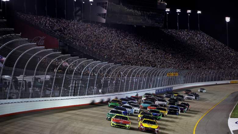 NASCAR Cup Series cars race under the lights during the Cracker Barrel 400 at Nashville Superspeedway in Tennessee.