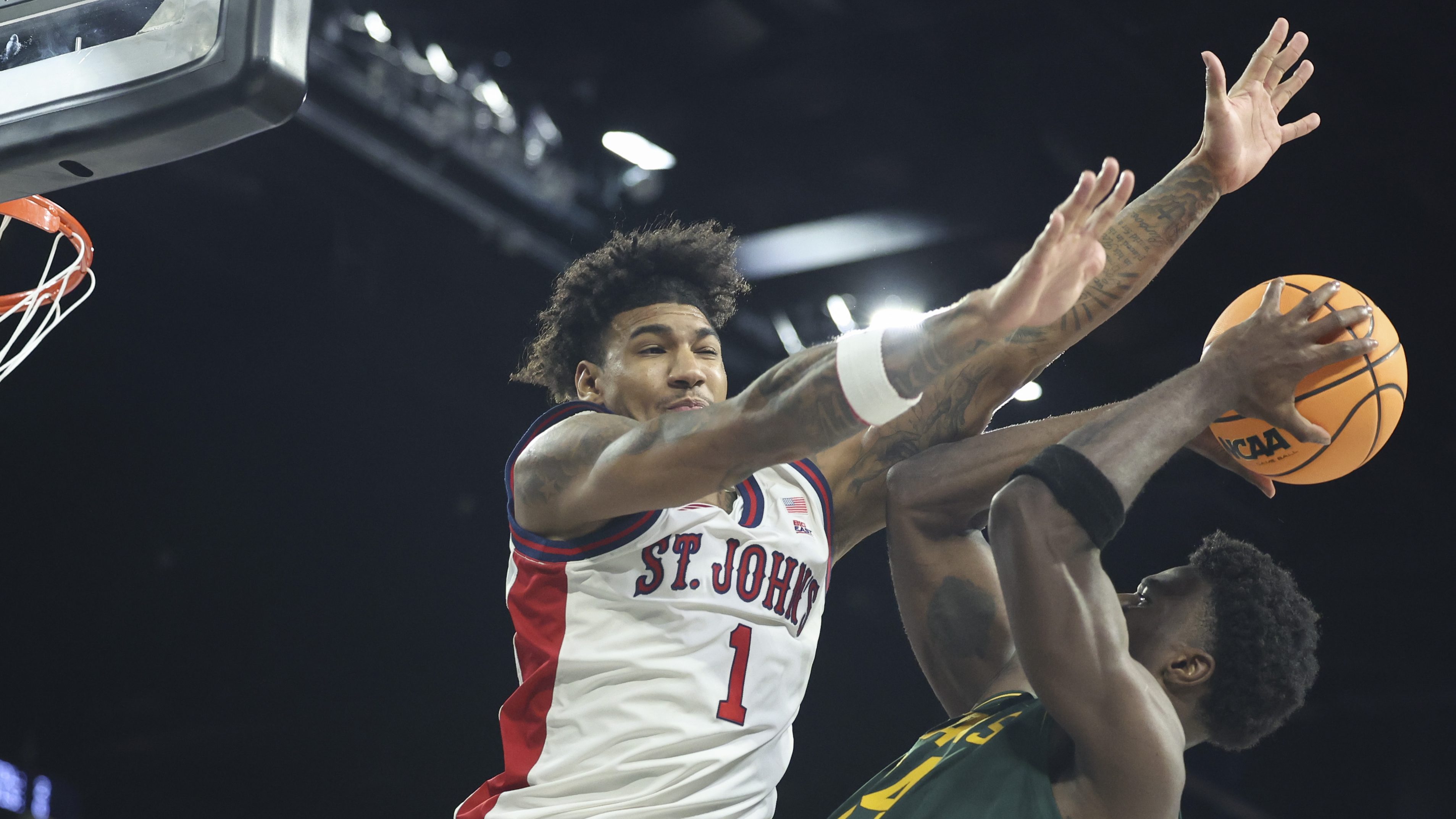St. John’s forward Dillon Mitchell contests Baylor forward Tounde Yessoufou at the rim during college basketball game action