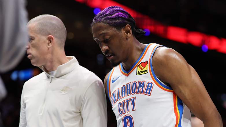 Jalen Williams of the Oklahoma City Thunder being helped off the court by staff after apparent hamstring injury during playoff game