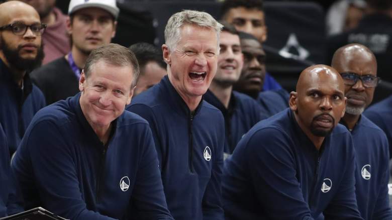 Steve Kerr and Golden State Warriors coaching staff on bench during NBA game