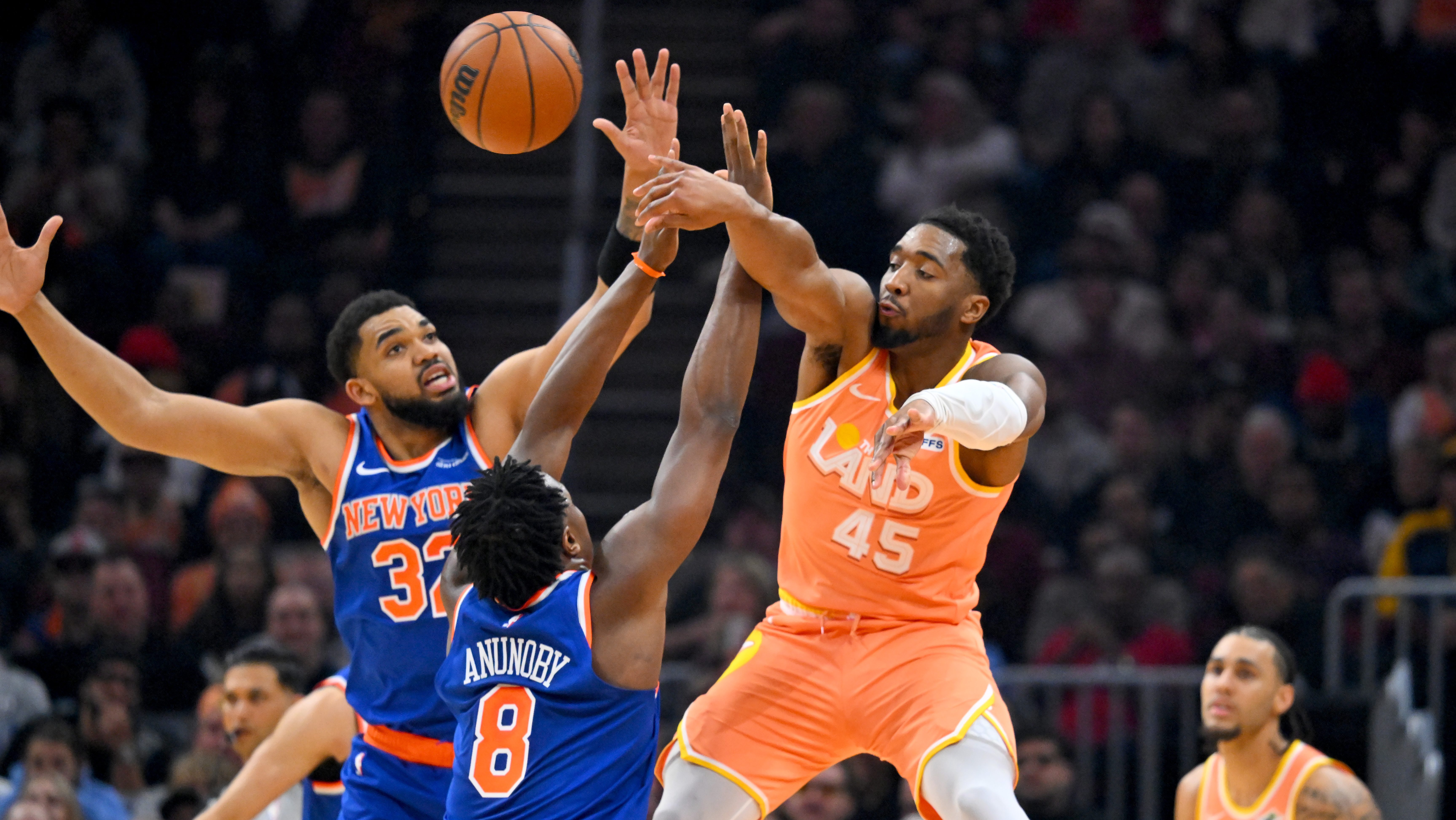 Cleveland Cavaliers guard Donovan Mitchell passes under pressure from New York Knicks defender OG Anunoby during NBA playoff game