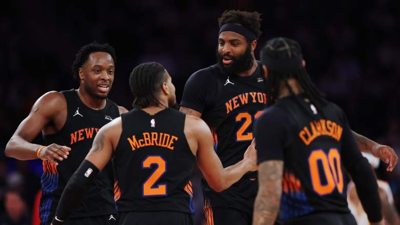 Mitchell Robinson talks with New York Knicks teammates during a playoff game as the team awaits further updates on his fractured pinky finger ahead of the NBA Finals.