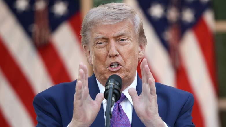 Donald Trump speaking at a podium with American flags behind him