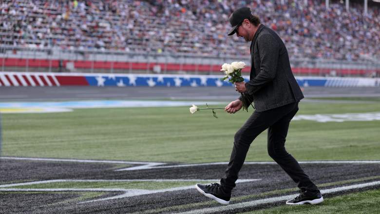 Kurt Busch lays white roses on the No. 8 before the Coca-Cola 600 tribute ceremony for Kyle Busch at Charlotte Motor Speedway.