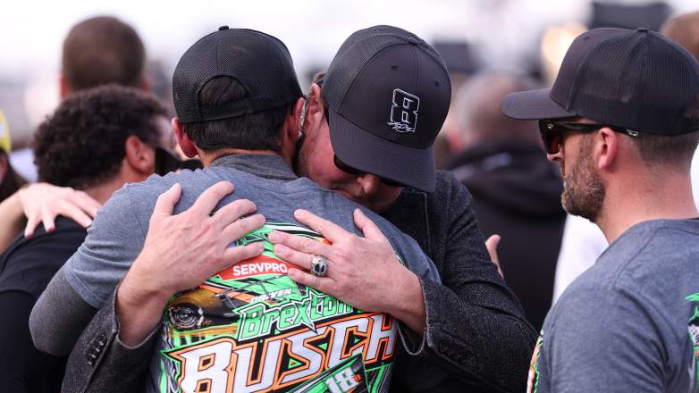 Kurt Busch and Chase Elliott embrace during a remembrance ceremony for Kyle Busch before the Coca-Cola 600 at Charlotte Motor Speedway.