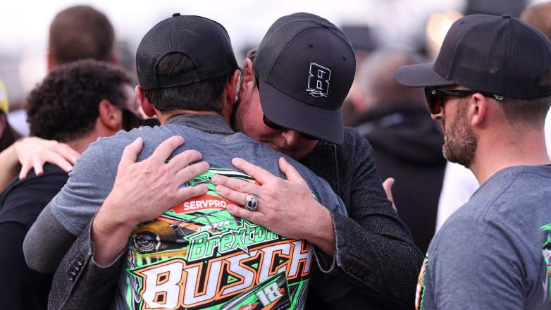 Chase Elliott hugs Kurt Busch during a pre-race tribute honoring Kyle Busch at Charlotte Motor Speedway.