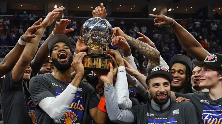 Karl-Anthony Towns and Jose Alvarado celebrate with the Eastern Conference championship trophy after the New York Knicks advanced to the NBA Finals.