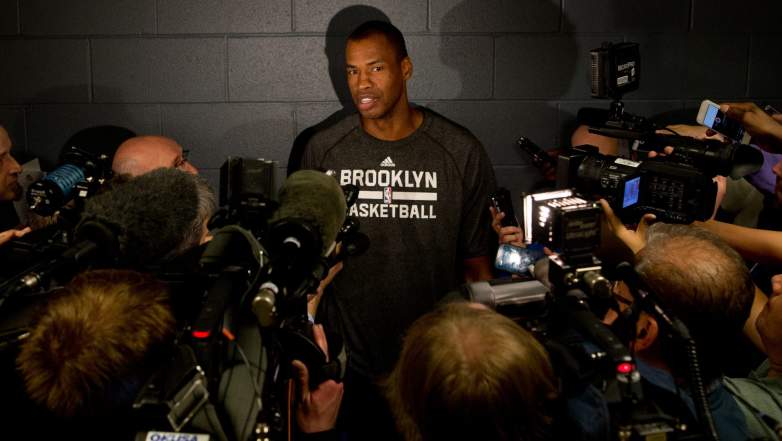 Jason Collins surrounded by media during a press conference with the Brooklyn Nets