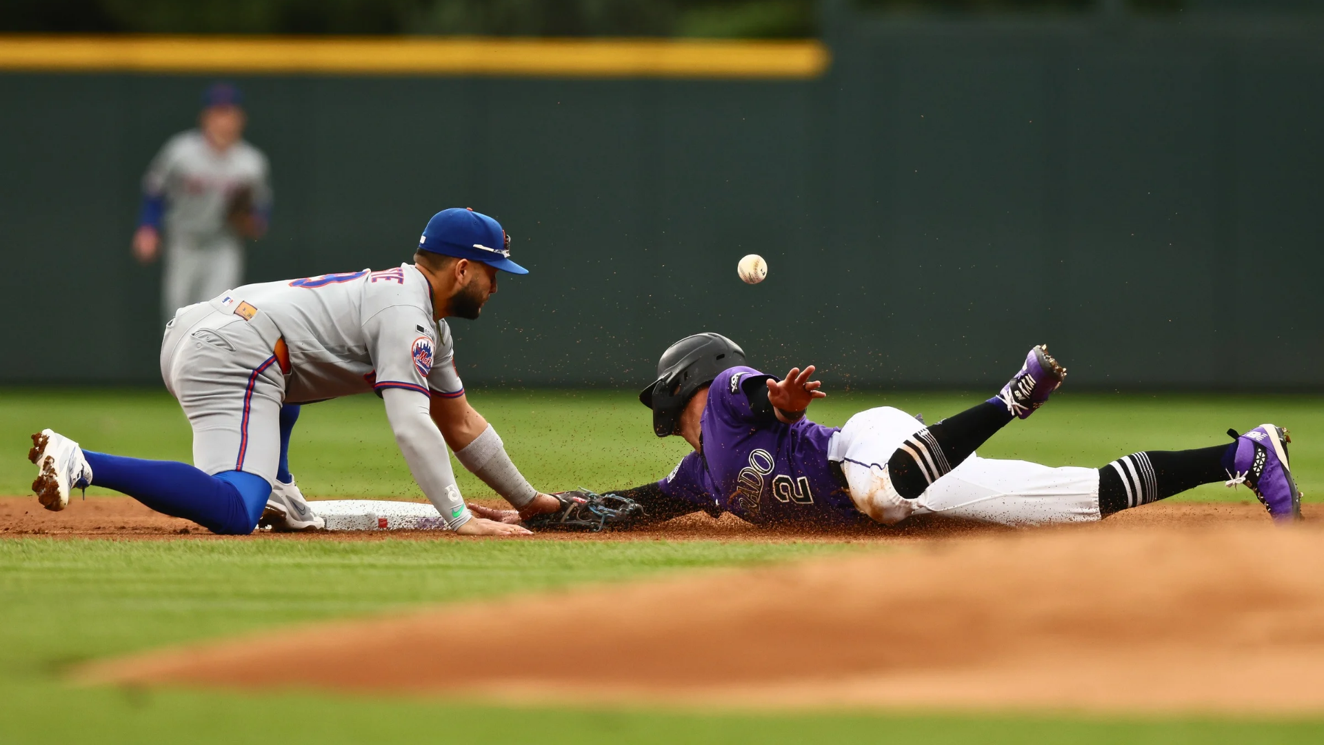 Tyler Freeman #2 of the Colorado Rockies safely slides in to steal second base as Bo Bichette #19 of the New York Mets can't control the ball in the first inning at Coors Field on May 4, 2026 in Denver, Colorado. (Photo by Justin Edmonds/Getty Images)