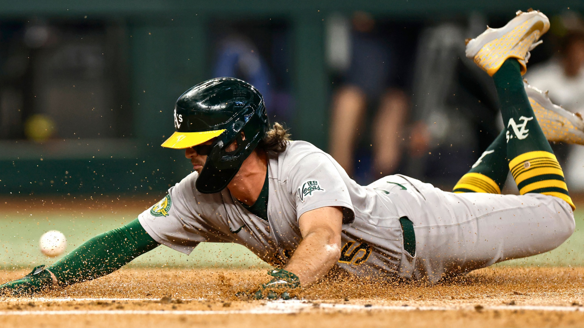 Jacob Wilson #5 of the Athletics slides across home plate to score a run against the Texas Rangers during the second inning at Globe Life Field on April 25, 2026 in Arlington, Texas. (Photo by Ron Jenkins/Getty Images)