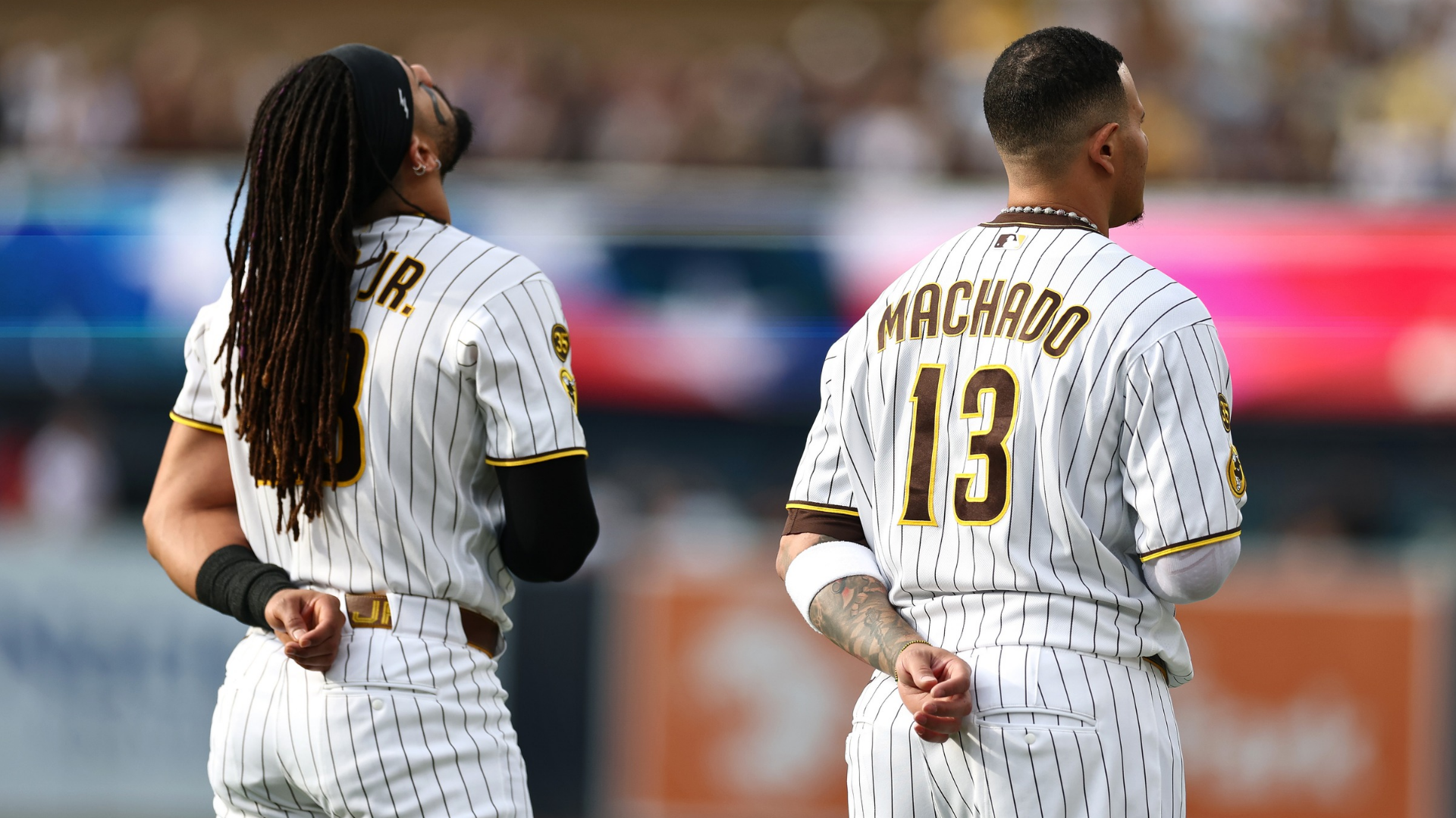 Manny Machado #13 and Fernando Tatis Jr. #23 of the San Diego Padres stands during the national anthem prior to a game against the Chicago White Sox at Petco Park on May 02, 2026 in San Diego, California. (Photo by Sean M. Haffey/Getty Images)