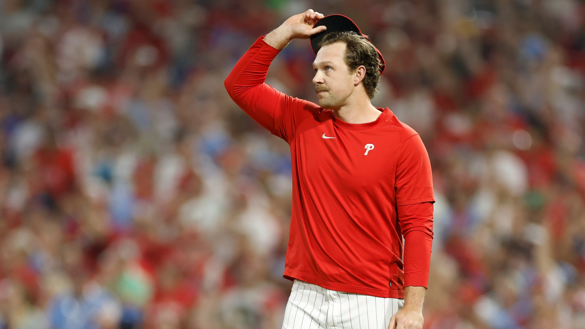 Rhys Hoskins #17 of the Philadelphia Phillies acknowledges fans before throwing out the ceremonial first pitch prior to Game One of the Wild Card Series between the Miami Marlins and the Philadelphia Phillies at Citizens Bank Park on October 03, 2023 in Philadelphia, Pennsylvania. (Photo by Sarah Stier/Getty Images)