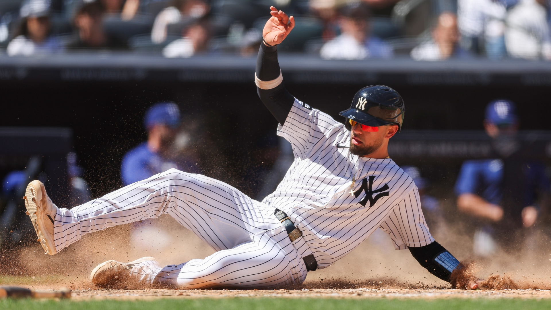 J.C. Escarra #25 of the New York Yankees slides into home off a single hit by Aaron Judge #99 during the six inning against the Texas Rangers at Yankee Stadium on May 07, 2026 in the Bronx borough of New York City. (Photo by Ishika Samant/Getty Images)
