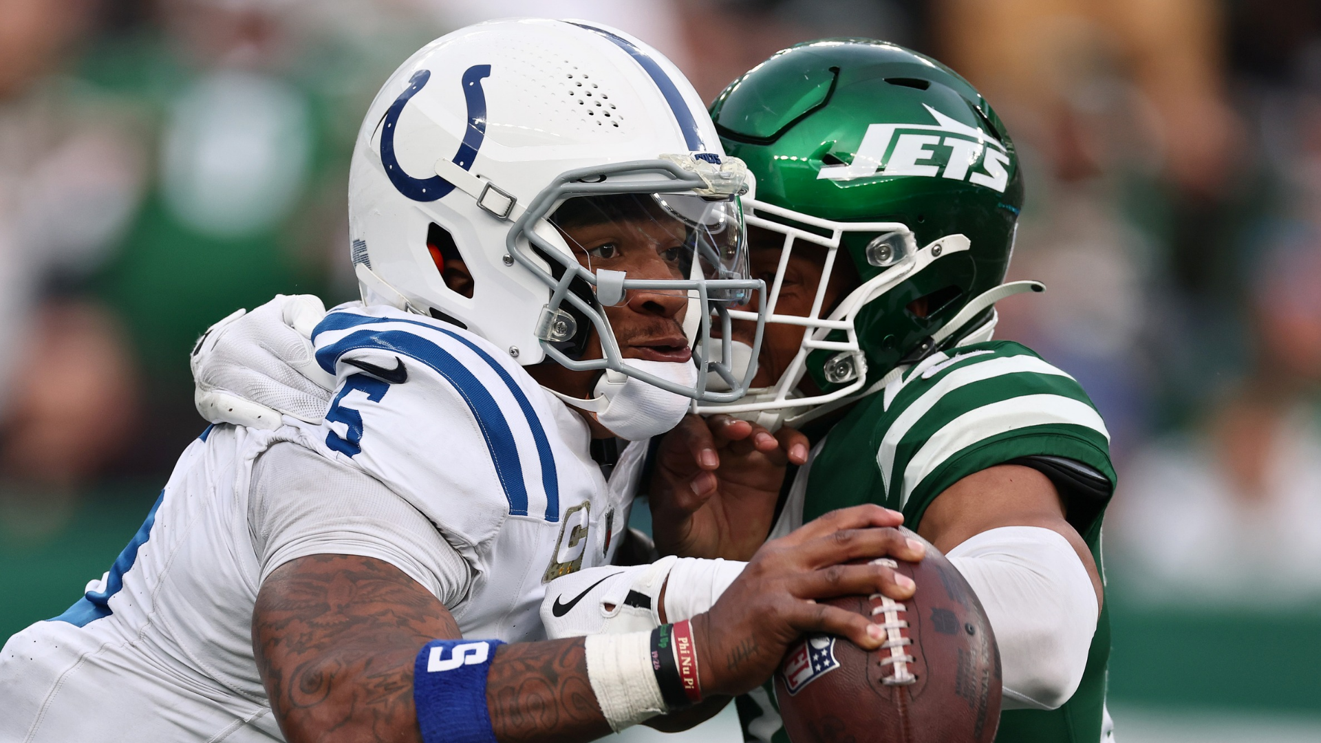 Quarterback Anthony Richardson #5 of the Indianapolis Colts holds off Isaiah Oliver #23 of the New York Jets as he scrambles during the fourth quarter at MetLife Stadium on November 17, 2024 in East Rutherford, New Jersey. (Photo by Al Bello/Getty Images)