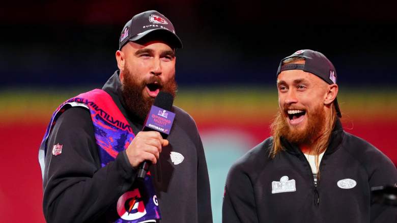 Travis Kelce of the Kansas City Chiefs (L) and George Kittle of the San Francisco 49ers stand on stage during Super Bowl LVIII Opening Night at Allegiant Stadium on February 05, 2024 in Las Vegas, Nevada