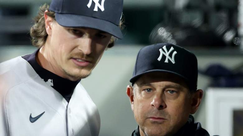 Max Fried speaks with Aaron Boone during a Yankees game as the ace landed on the injured list with an elbow bone bruise.