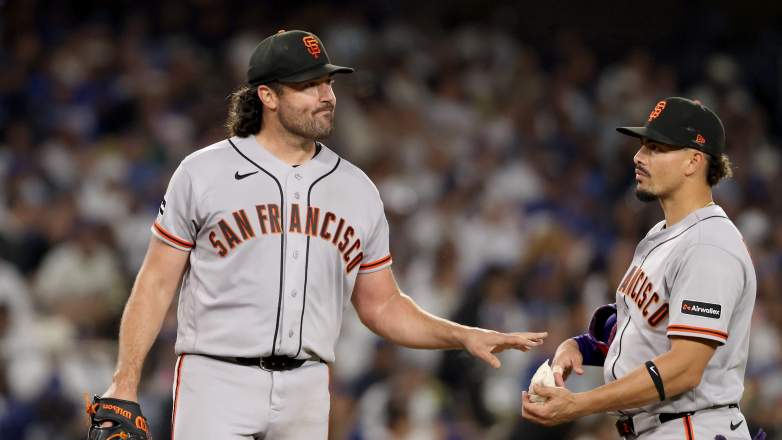 San Francisco Giants starting pitcher Robbie Ray grabs the rosin bag from shortstop Willy Adames at Dodger Stadium.