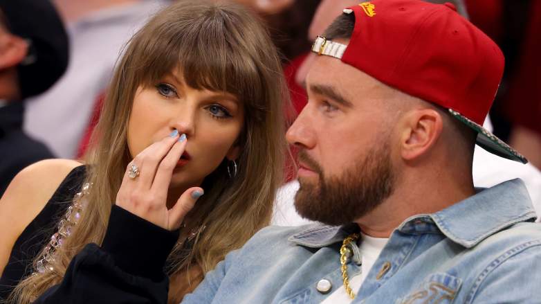Taylor Swift whispers to Travis Kelce during a Cleveland Cavaliers game after Kelce's viral beer-chug.