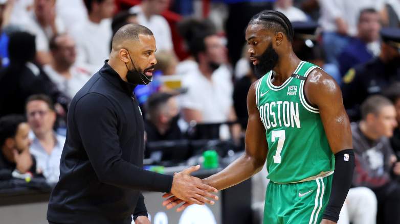 Former Celtics coach Ime Udoka speaks with Jaylen Brown during a playoff game. Udoka is now the head coach of the Houston Rockets, a team reportedly monitoring Brown's situation.