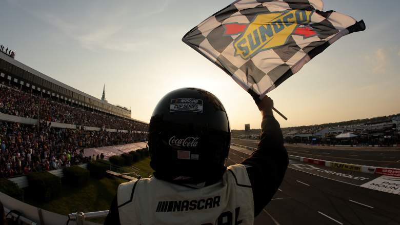A NASCAR official waves the checkered flag at Pocono Raceway during the Great American Getaway 400 in Long Pond, Pennsylvania.