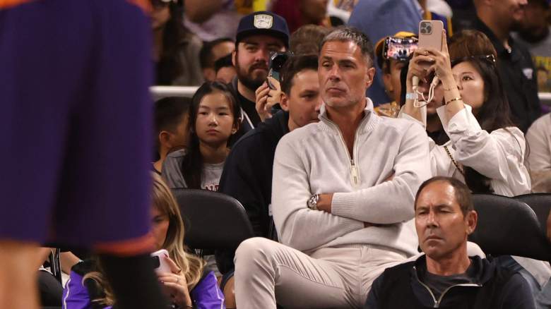 Los Angeles Lakers president of basketball operations Rob Pelinka sits courtside during a Lakers game as the team continues its front-office restructuring ahead of the NBA offseason.