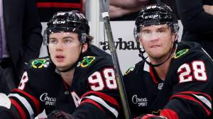 Oliver Moore #11, Connor Bedard #98 and Andre Burakovsky #28 of the Chicago Blackhawks look on against the Anaheim Ducks during the first period at the United Center on November 30, 2025 in Chicago, Illinois.