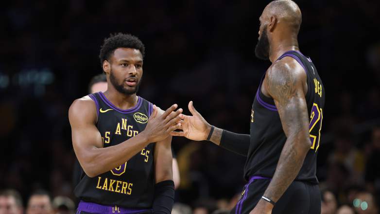 Bronny James and LeBron James greet each other during a Los Angeles Lakers game against the Atlanta Hawks.