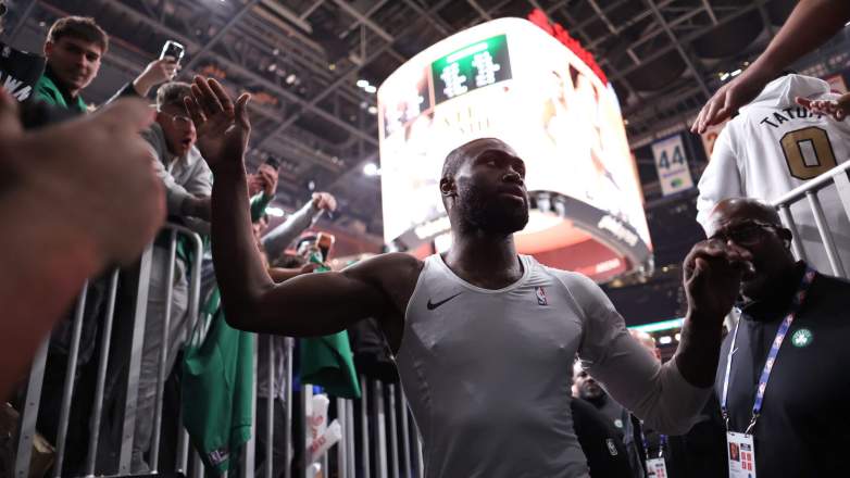Boston Celtics star Jaylen Brown acknowledges fans while leaving the court at State Farm Arena in Atlanta.